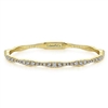 This artful 14k yellow gold diamond bangle features over one carat of gradated round diamonds.