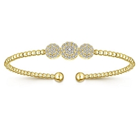 This 14k yellow gold cuff style bangle bracelet features one third carats of diamond shine.