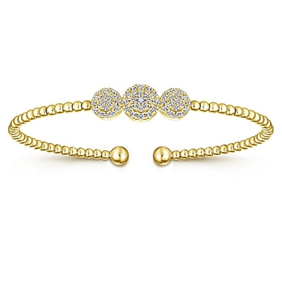 This 14k yellow gold cuff style bangle bracelet features one third carats of diamond shine.