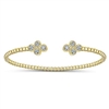 This simple cuff features a thin band of 14k yellow gold with diamonds centered in a cluster settings.