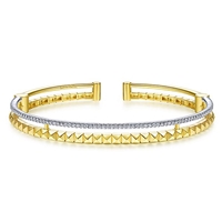 This 14k two tone cuff bangle features one half carats of diamonds.