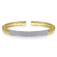 This 14k yellow gold cuff bangle features 2 carats of diamonds.