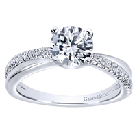 This cool round diamond engagement ring maintains a fresh and contemporary look with a single round diamond row that crosses over sleek white gold or platinum .