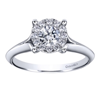 This subtle and sublime solitaire engagement ring features a split shank and holds a round center diamond,available in white gold or platinum.