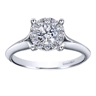 This subtle and sublime solitaire engagement ring features a split shank and holds a round center diamond,available in white gold or platinum.
