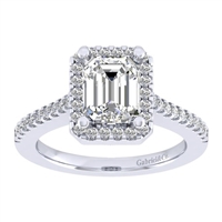 This subtle and clean emerald cut diamond halo engagement ring with over on third carats of round diamonds shimmers and glistens in white gold or platinum.
