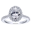 Round brilliant diamonds climb their way up this white gold or platinum band to form a diamond halo surrounding an oval cut diamond of your choice in this diamond oval halo engagement ring!