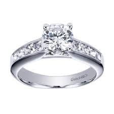 In white gold or platinum, this contemporary halo engagement ring explodes with 3/4 carats of round brilliant diamonds,