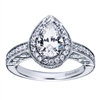 Fine metal work and round brilliant diamonds blend to form this vintage style halo engagement ring intended for a pear shape center diamond, available in white gold or platinum.