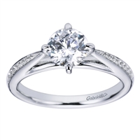 An 18k white gold contemporary straight engagement ring with a twist, featuring round brilliant diamonds and a six prong setting in this engagement ring,