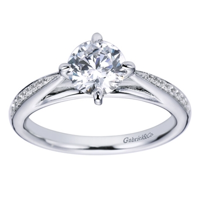 An 18k white gold contemporary straight engagement ring with a twist, featuring round brilliant diamonds and a six prong setting in this engagement ring,