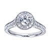 Featured in white gold and available in platinum, this wittily crafted vintage style halo engagement ring contains over one half carat in round brilliant diamonds.