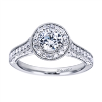 Featured in white gold and available in platinum, this wittily crafted vintage style halo engagement ring contains over one half carat in round brilliant diamonds.