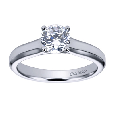 Sometimes a round center diamond just needs to be left alone! With this contemporary solitaire engagement ring will let that round center diamond shine.