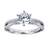 Intricately set round brilliant diamonds shimmer and glisten, setting up a round center diamond in the midst of one quarter carats of diamonds in this platinum split shank diamond engagement ring.