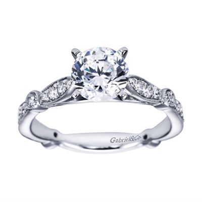 A meticulously crafted and carefully designed artistic vintage style engagement ring with round brilliant diamonds fitting a round center diamond