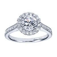A milgrain finish with round brilliant diamonds make this contemporary halo engagement ring a refreshing and uplifting choice.