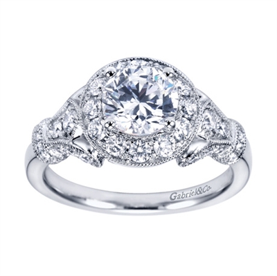 Feast your eyes on this immaculate white gold vintage halo engagement ring bustling with 0.65 carats of round brilliant diamonds, also available in platinum.