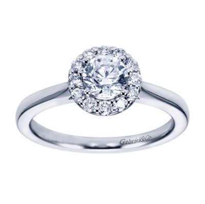 A round brilliant halo contrasts perfectly with the sleek white gold band in this contemporary halo engagement ring available in platinum or white gold.