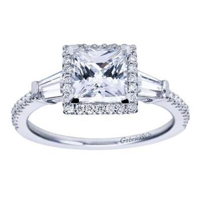 Round brilliant diamonds form a glistening halo while side baguette diamonds are a great accompaniment to a center princess cut diamond in this diamond-laden 14k white gold princess halo engagement ring.