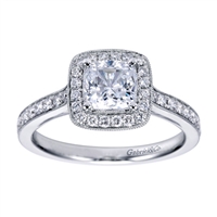 A white gold and round brilliant diamond creation that will have the round center diamond sparkling in this vintage halo engagement ring.