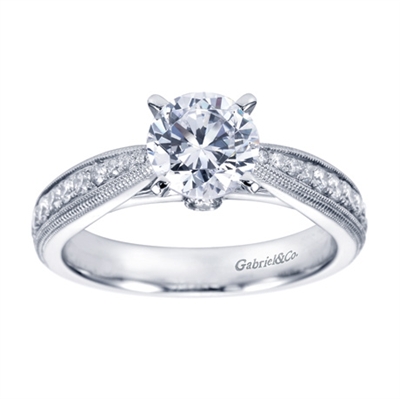 A modern day take on a victorian style engagement ring with round brilliant diamonds.