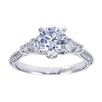 A 3 stone diamond engagement ring with intricate metal work and a flair for the dramatic.