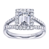 This split shank halo engagement ring perfectly houses an emerald cut center diamond with nearly one half carats of round brilliant diamonds.