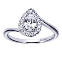 This delicious pear cut diamond engagement ring features a round brilliant diamond halo with a twisted and swirled white gold or platinum band in this diamond pear halo engagement ring.