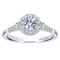 This white gold diamond engagement ring comes with a round center diamond and a beautiful round diamond halo to hold in all that shine!
