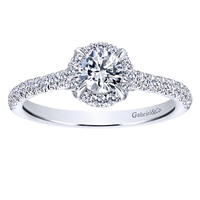 This stunning round diamond halo engagement ring features nearly one full carat of round diamonds and is included with a center diamond!