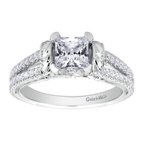 This diamond studded split shank princess cut diamond engagement ring glistens with 0.39 carats of round brilliant diamonds, all cushioning a princess cut center diamond.