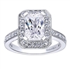 This diamond halo engagement ring snugly wraps 2/3 carats of round brilliant diamonds around an emerald cut center diamond.