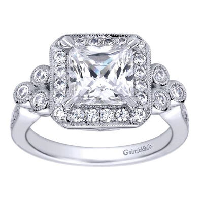 Two sets of triple round diamonds offset this diamond halo engagement ring for a princess cut center diamond. With over one half carats for round diamonds, this engagement ring has plenty to stare at!