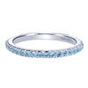 A row of blue topaz stones shine in this 14k white gold stackable ring.