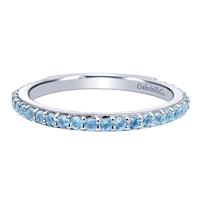 A row of blue topaz stones shine in this 14k white gold stackable ring.