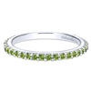 A row of peridot stones shimmer in this 14k white gold stackable ring.