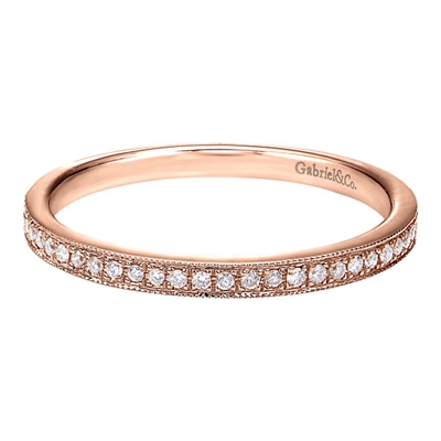 This 14k rose gold diamond stackable ring features round brilliant diamonds set in a delicate and modern rose gold band.