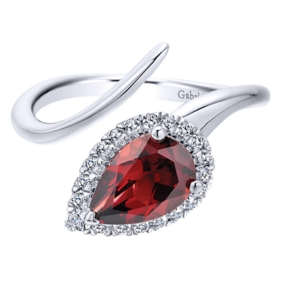 Beautiful 14k white gold served as the canvas for a single garnet with a diamond halo to surround the fiery red garnet in glamor.