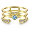 This 14k yellow gold ring is stacked with blue topaz and diamonds.