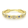 This 14k yellow gold sapphire and diamond ring is a stackable style.