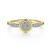 This 14k yellow gold diamond bezel ring features a cluster of shimmering diamonds.