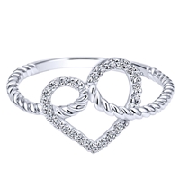 Brilliant round diamonds form a center heart in this braided and fun 14k white gold heart ring.