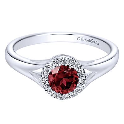 A gorgeous center garnet is gently surrounded by diamond shine in this garnet and diamond halo ring in 14k white gold.