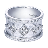 This gorgeous sterling silver wide diamond band features 0.19 carats of round brilliant diamond shine in a wide band.