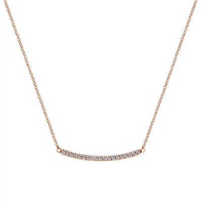 Stylish rose gold showcases 0.20 carats in round brilliant diamonds in this naturally curving bar necklace.