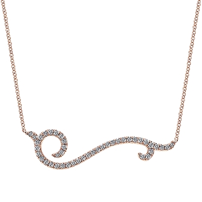 In 14k rose gold, this stylish diamond bar necklace features a slight twist in its 14k gold setting, with 0.60 carats of diamonds.