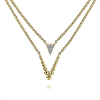 This trendy yellow gold diamond necklace features two layered sections in 14k yellow gold.