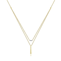 Two layered necklaces in one 14k yellow diamond bar necklace.