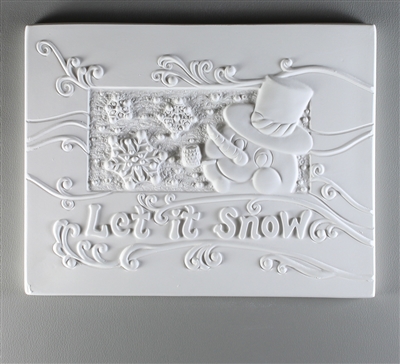 A rectangular tile of white ceramic with a carved design. The center has a smaller rectangle with a cartoon snowman face on the right and the rest filled with snowflakes. Curving text below reads Let it Snow, and the background is filled with windy lines.